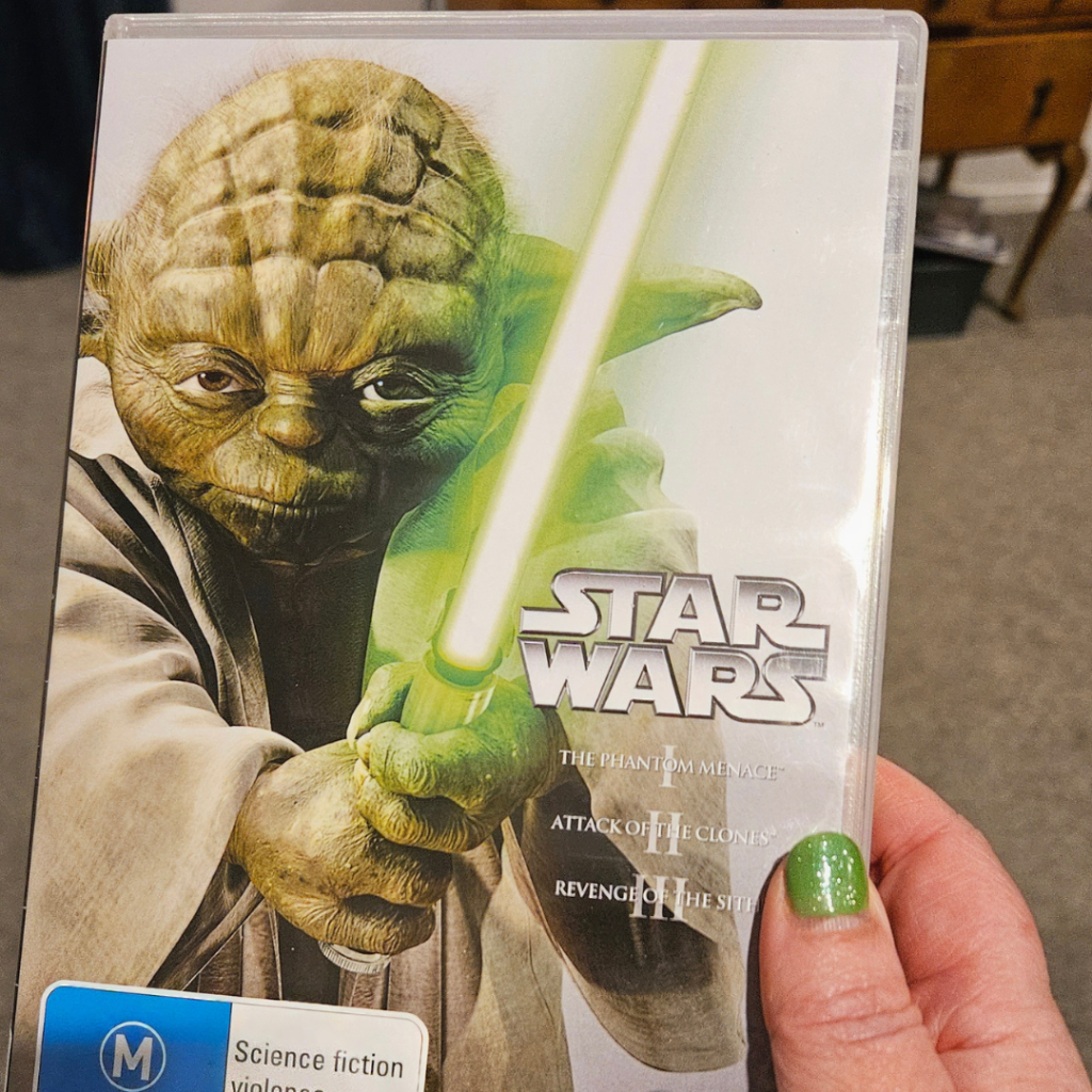 a hand holding a dvd case with the title star wars mindful movie nights